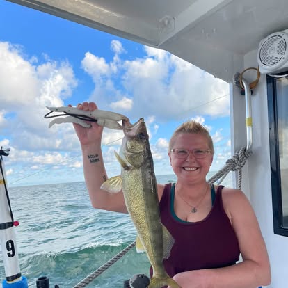 Guest holding a walleye